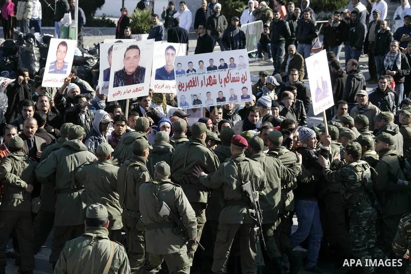 Tunisian protesters gather to demand a new government free of officials of the ousted regime of former president Zine el Abidine Ben Ali, near the Prime Minister's office in Tunis, Tunisia, 24 January 2011. According to...
