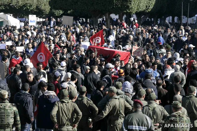 Tunisian protesters gather to demand a new government free of officials of the ousted regime of former president Zine el Abidine Ben Ali, near the Prime Minister's office in Tunis, Tunisia, 24 January 2011. According to...
