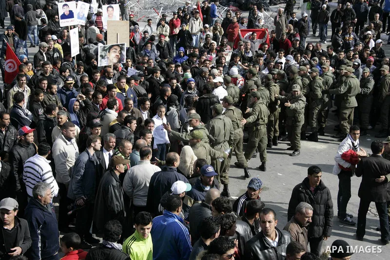 Tunisian protesters gather to demand a new government free of officials of the ousted regime of former president Zine el Abidine Ben Ali, near the Prime Minister's office in Tunis, Tunisia, 24 January 2011. According to...