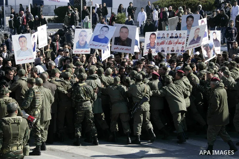 Tunisian protesters gather to demand a new government free of officials of the ousted regime of former president Zine el Abidine Ben Ali, near the Prime Minister's office in Tunis, Tunisia, 24 January 2011. According to...