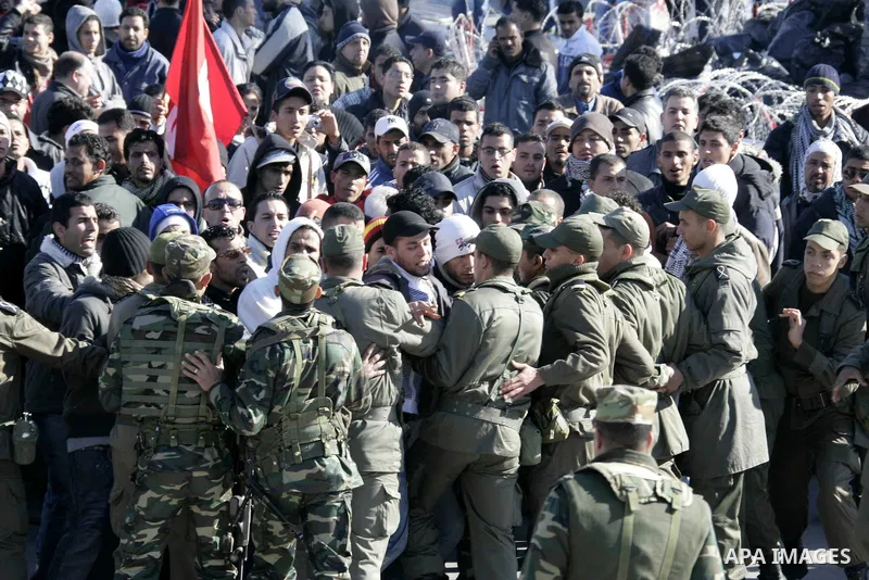 Tunisian protesters gather to demand a new government free of officials of the ousted regime of former president Zine el Abidine Ben Ali, near the Prime Minister's office in Tunis, Tunisia, 24 January 2011. According to...