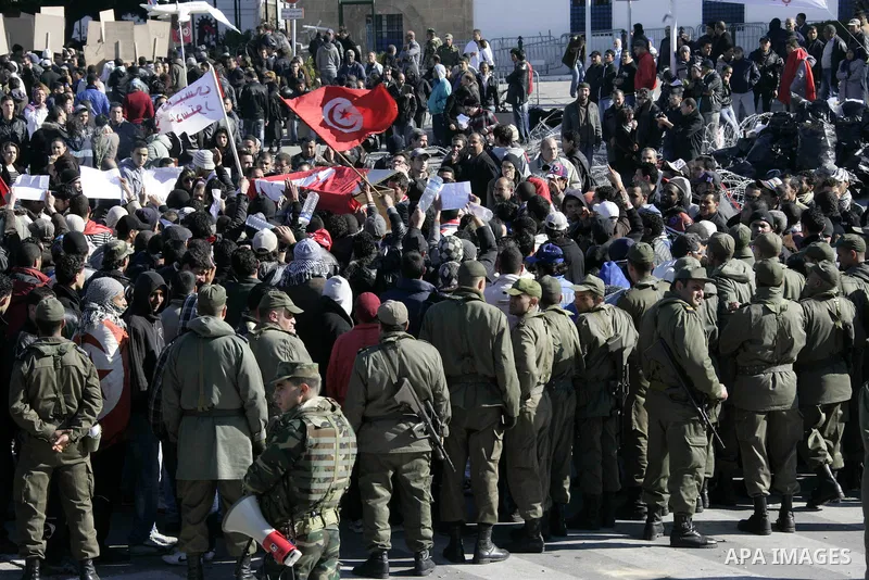 Tunisian protesters gather to demand a new government free of officials of the ousted regime of former president Zine el Abidine Ben Ali, near the Prime Minister's office in Tunis, Tunisia, 24 January 2011. According to...