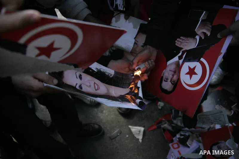 Tunisian Protesters from Tunisia's marginalised burn a picture of their President Zine al-Abidine Ben Ali during a protest to demand a new government free of officials of the ousted regime of former president Zine el Abi...