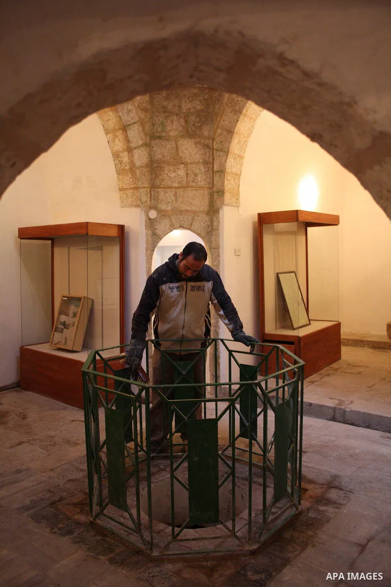 A Palestinian laborer works near a callgraphic works during the opening of the ( Old City Museum ) in the old city of the West Bank city of Hebron on January 25, 2011. The museum located in " Haret Dari " near the Khan a...