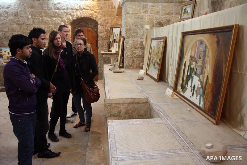 Visitors look at callgraphic works during the opening of the ( Old City Museum ) in the old city of the West Bank city of Hebron on January 25, 2011. The museum located in " Haret Dari " near the Khan al-Khalil, it was o...