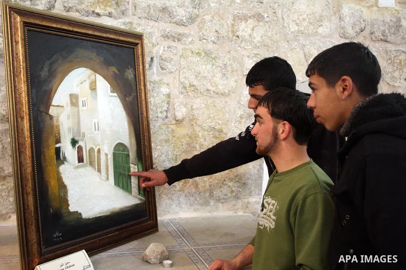 Visitors look at callgraphic works during the opening of the ( Old City Museum ) in the old city of the West Bank city of Hebron on January 25, 2011. The museum located in " Haret Dari " near the Khan al-Khalil, it was o...