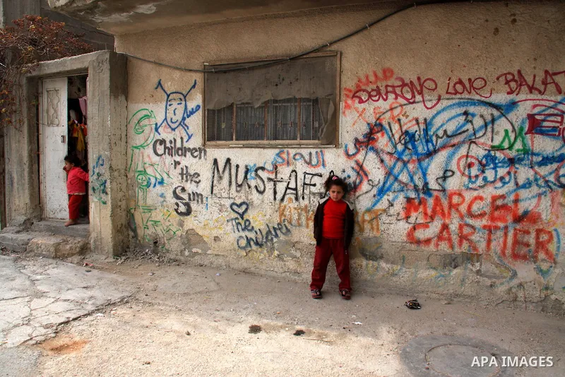 Palestinian children stand in alley in the Balata refugee camp in the northern West Bank city of Nablus on January 25, 2011, a day after it was leaked by Al-Jazeera in revealed documents that Palestinian negotiators acce...