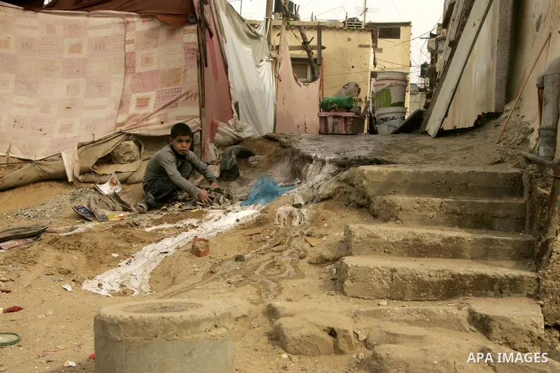 Palestinian children play in alley in the Rafah refugee camp in the southern Gaza Strip on January 25, 2011, a day after it was leaked by Al-Jazeera in revealed documents that Palestinian negotiators accepted Israel's pr...