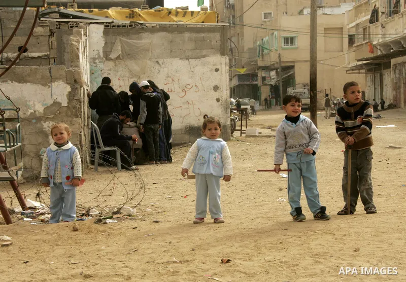 Palestinian children play in alley in the Rafah refugee camp in the southern Gaza Strip on January 25, 2011, a day after it was leaked by Al-Jazeera in revealed documents that Palestinian negotiators accepted Israel's pr...