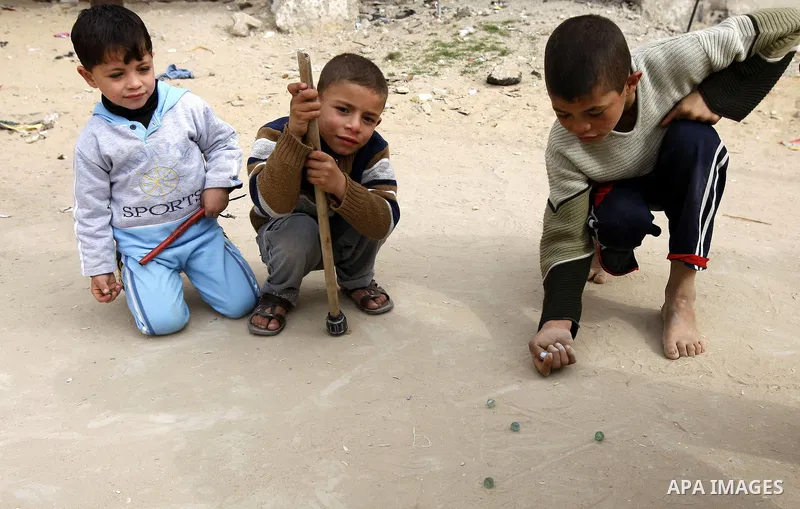 Palestinian children play in alley in the Rafah refugee camp in the southern Gaza Strip on January 25, 2011, a day after it was leaked by Al-Jazeera in revealed documents that Palestinian negotiators accepted Israel's pr...