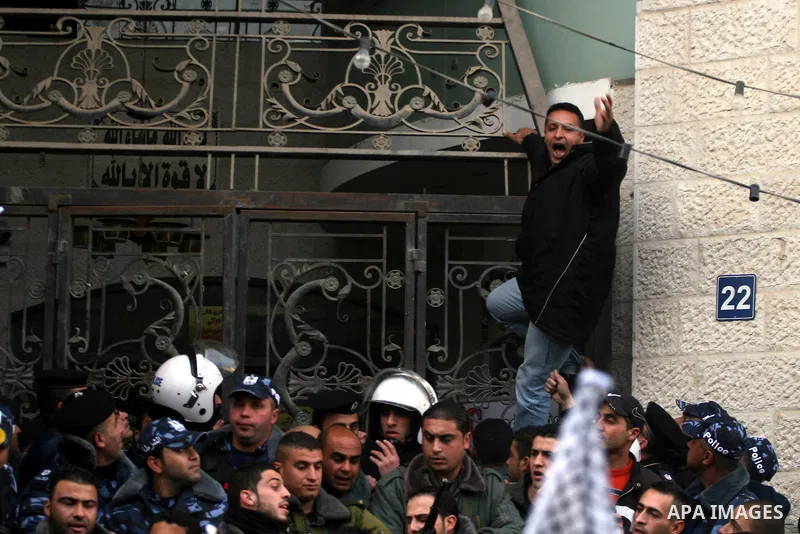 Palestinians supporters of the President Mahmoud Abbas gather next to Al-Jazeera office in the West Bank town of Ramallah, to protest against Al-Jazeera TV Channel on 25 January 2011. Palestinian negotiators privately ag...