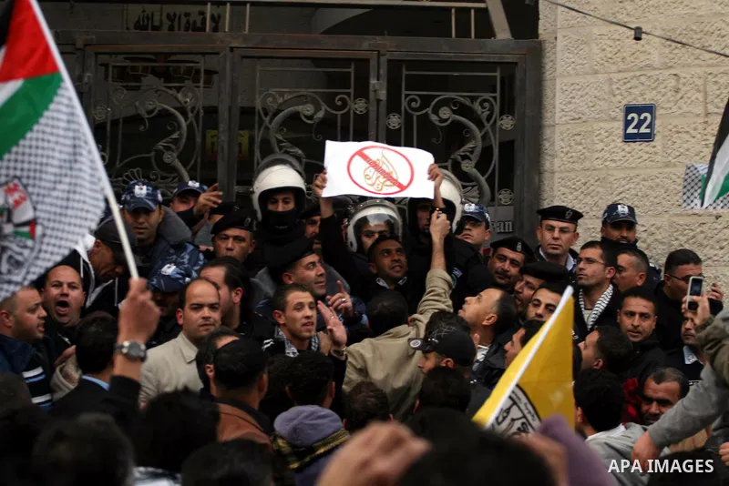 Palestinians supporters of the President Mahmoud Abbas gather next to Al-Jazeera office in the West Bank town of Ramallah, to protest against Al-Jazeera TV Channel on 25 January 2011. Palestinian negotiators privately ag...