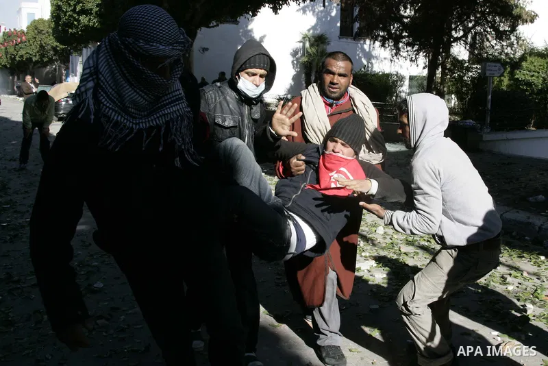 Tunisian policemen fire tear gas canisters at protestors during a demonstration against Prime Minister Mohammed Ghannouchi in front of the government palace in Tunis.Tunisia, 26 January 2011, Hundreds of defiant Tunisian...