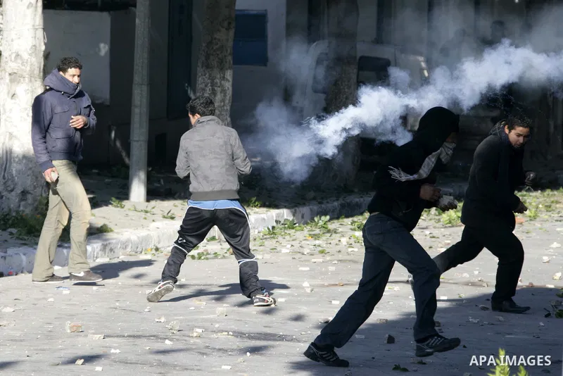 Tunisian policemen fire tear gas canisters at protestors during a demonstration against Prime Minister Mohammed Ghannouchi in front of the government palace in Tunis.Tunisia, 26 January 2011, Hundreds of defiant Tunisian...