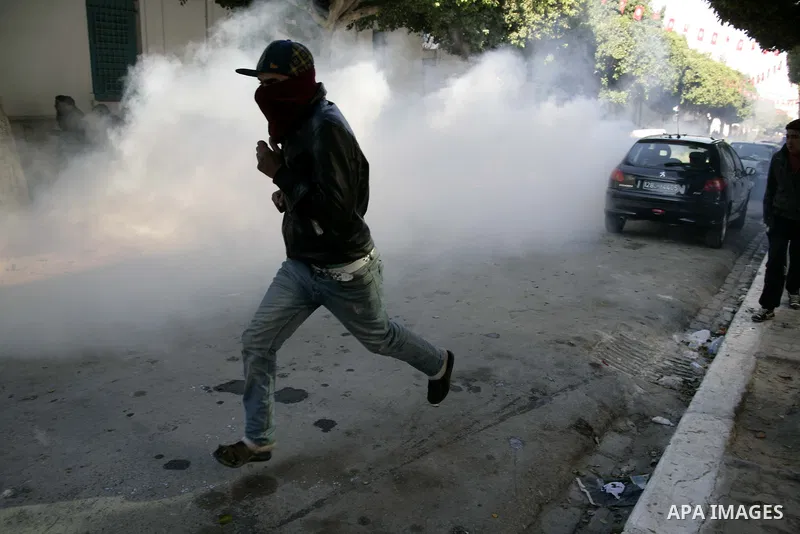 Tunisian policemen fire tear gas canisters at protestors during a demonstration against Prime Minister Mohammed Ghannouchi in front of the government palace in Tunis.Tunisia, 26 January 2011, Hundreds of defiant Tunisian...