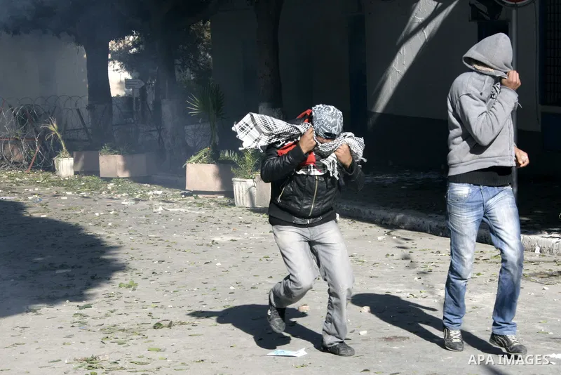 Tunisian policemen fire tear gas canisters at protestors during a demonstration against Prime Minister Mohammed Ghannouchi in front of the government palace in Tunis.Tunisia, 26 January 2011, Hundreds of defiant Tunisian...