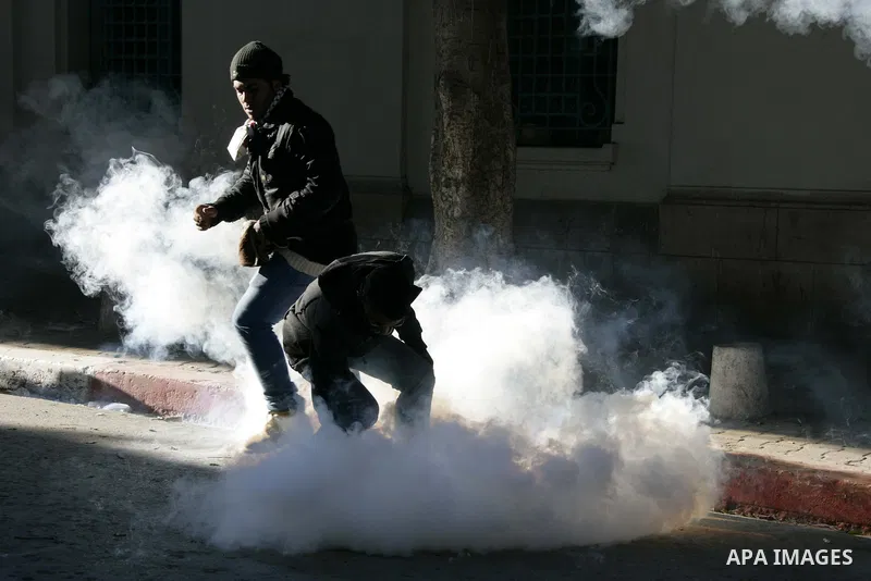 Tunisian policemen fire tear gas canisters at protestors during a demonstration against Prime Minister Mohammed Ghannouchi in front of the government palace in Tunis.Tunisia, 26 January 2011, Hundreds of defiant Tunisian...