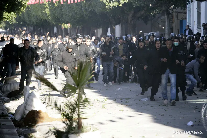 Tunisian policemen fire tear gas canisters at protestors during a demonstration against Prime Minister Mohammed Ghannouchi in front of the government palace in Tunis.Tunisia, 26 January 2011, Hundreds of defiant Tunisian...