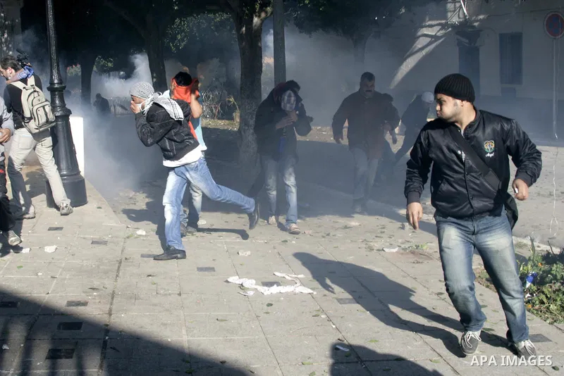 Tunisian policemen fire tear gas canisters at protestors during a demonstration against Prime Minister Mohammed Ghannouchi in front of the government palace in Tunis.Tunisia, 26 January 2011, Hundreds of defiant Tunisian...
