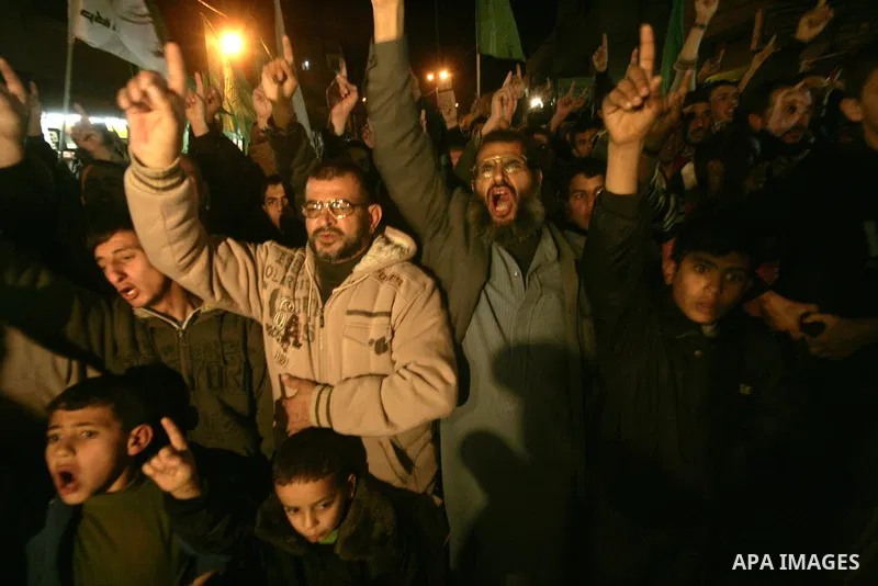 Palestinian Hamas activists take part rally against Abbas, following a recent broadcast by Al-Jazeera reportedly linking him to making broad concessions to Israel in peace talks, in Rafah, southern Gaza Strip, Wednesday,...