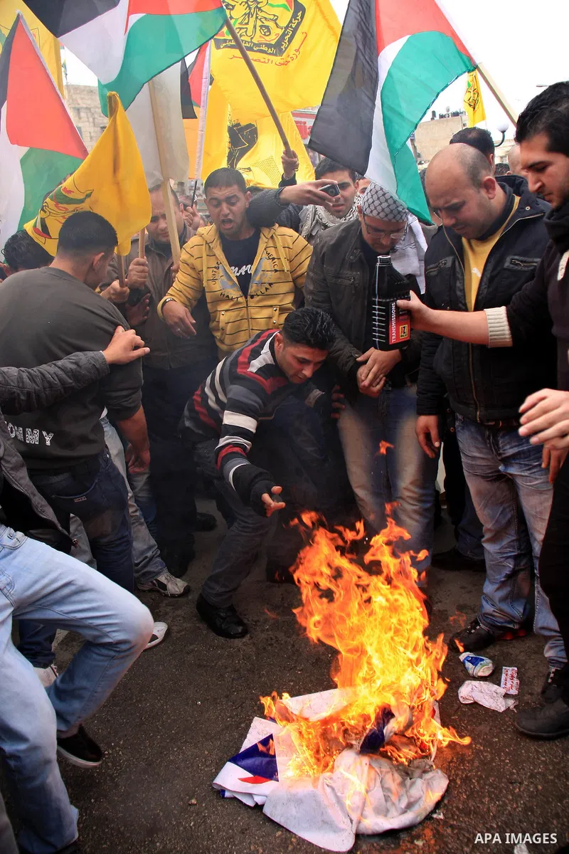 Palestinians burn Al-Jazeera logos during a rally in the West Bank City of Nablus , to protest against Al-Jazeera TV Channel on 27 January 2011. Al-Jazeera, a Qatar-based Arab satellite station, this week published excer...