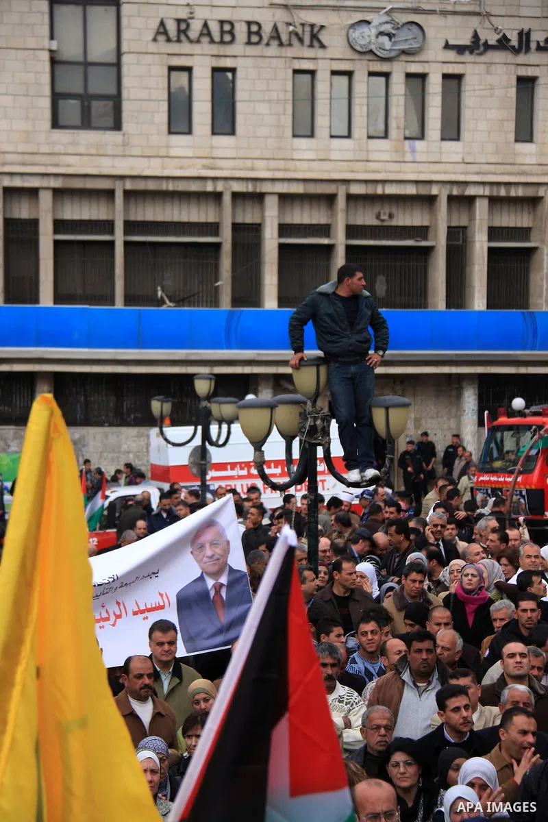 Palestinians hold Fatah flags and national flags during a rally in the West Bank City of Nablus , to protest against Al-Jazeera TV Channel on 27 January 2011. Al-Jazeera, a Qatar-based Arab satellite station, this week p...