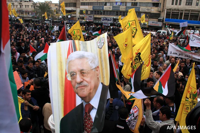 Palestinians hold Fatah flags and national flags during a rally in the West Bank City of Nablus , to protest against Al-Jazeera TV Channel on 27 January 2011. Al-Jazeera, a Qatar-based Arab satellite station, this week p...
