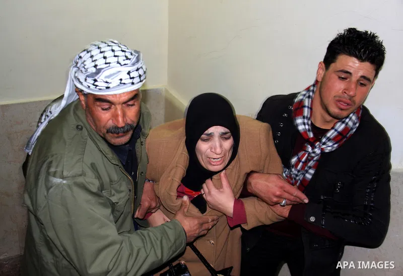 Palestinians mourn at the body of Maher Qadus, 18, into a hospital in the West Bank city of Nablus on January 27, 2011 after he was shot and killed by a Jewish settler, according to Palestinian security offcials. Photo b...