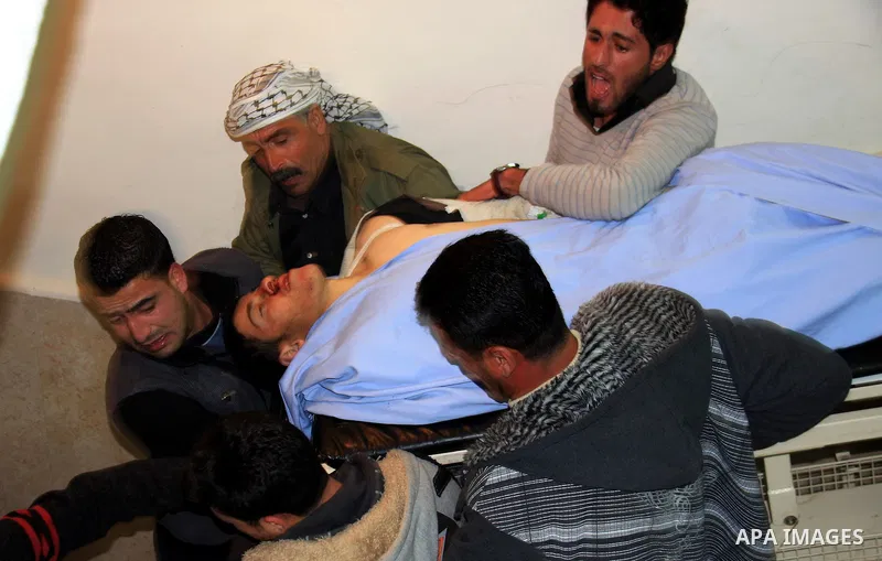 Palestinians mourn at the body of Maher Qadus, 18, into a hospital in the West Bank city of Nablus on January 27, 2011 after he was shot and killed by a Jewish settler, according to Palestinian security offcials. Photo b...