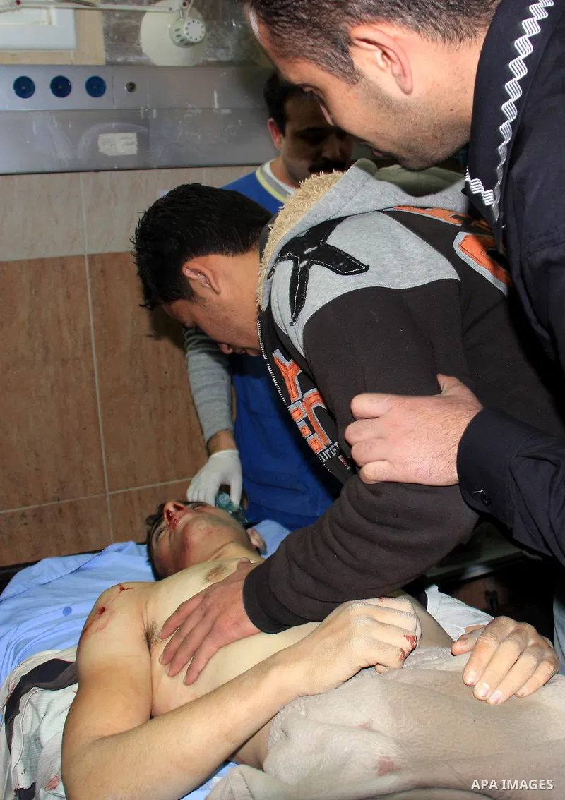 Palestinians mourn at the body of Maher Qadus, 18, into a hospital in the West Bank city of Nablus on January 27, 2011 after he was shot and killed by a Jewish settler, according to Palestinian security offcials. Photo b...