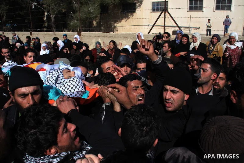 Palestinians carry the body of Uday Qadous, 18, who was shot and killed Thursday in the village of Iraq Burin, during his funeral at in the West Bank city of Nablus, Friday Jan. 28, 2011. Israeli police spokesman Micky R...