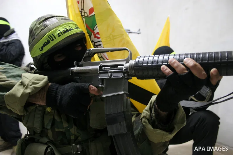 Palestinian militants of Fatah movement's armed wing 'al-Aqsa Martyrs Brigades' hold a press conference to show supports to President Mahmoud Abbas, in the West Bank city of Hebron, Jan. 27, 2011. Photo by Mamoun Wazwaz