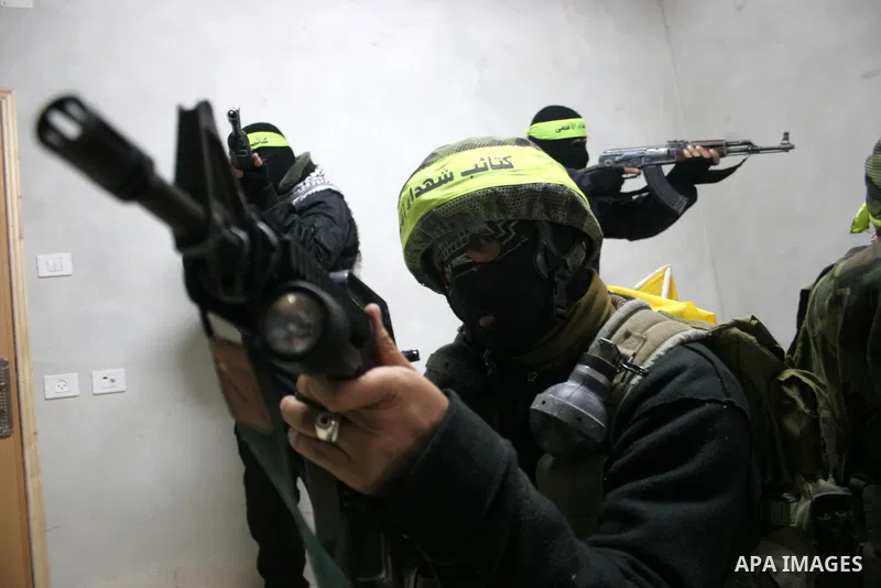 Palestinian militants of Fatah movement's armed wing 'al-Aqsa Martyrs Brigades' hold a press conference to show supports to President Mahmoud Abbas, in the West Bank city of Hebron, Jan. 27, 2011. Photo by Mamoun Wazwaz