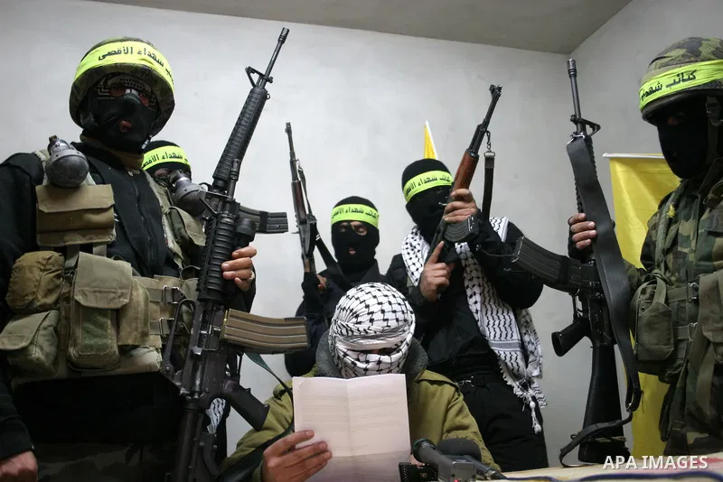 Palestinian militants of Fatah movement's armed wing 'al-Aqsa Martyrs Brigades' hold a press conference to show supports to President Mahmoud Abbas, in the West Bank city of Hebron, Jan. 27, 2011. Photo by Mamoun Wazwaz
