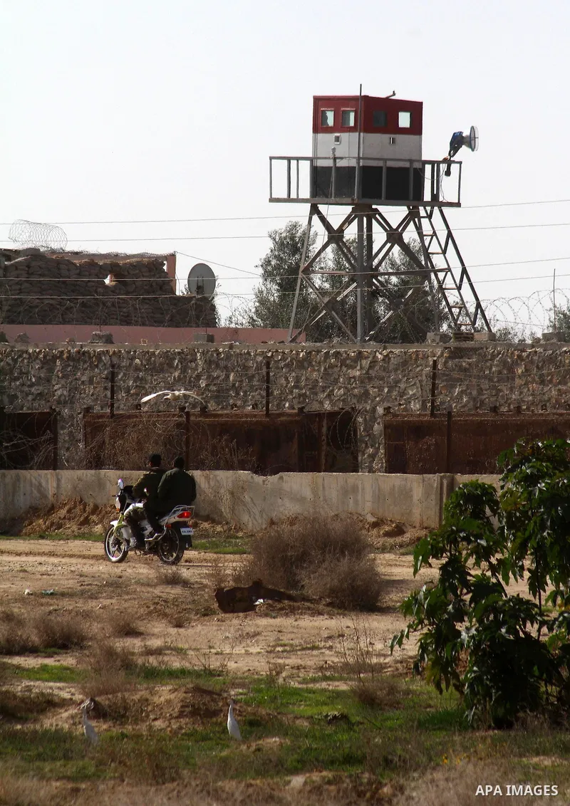 Palestinian youths ride their motorbike near the Egyptian border with the Gaza Strip in the city of Rafah, southern Gaza Strip on, 28 January 2011. The Egyptian authorities intensified security measures on the border wit...
