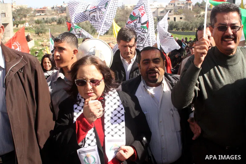 Palestinians take part in a protest against Israel's controversial separation barrier in the village of Bilin, near the West Bank city of Ramallah, on Jan. 28, 2011. Photo by STR