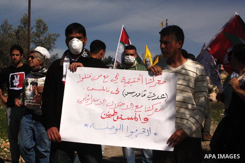 Palestinians take part in a protest against Israel's controversial separation barrier in the village of Bilin, near the West Bank city of Ramallah, on Jan. 28, 2011. Photo by STR