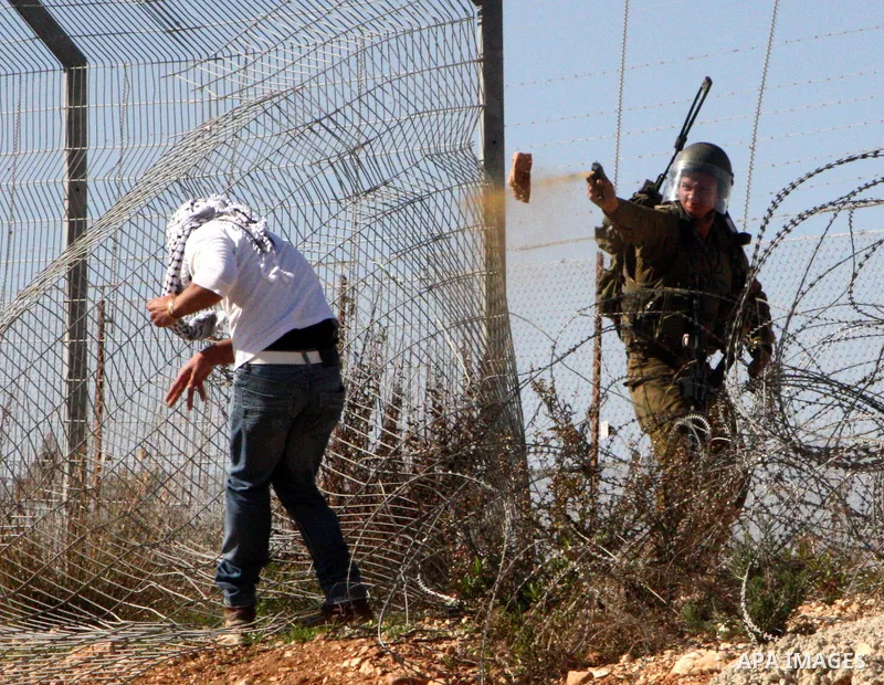 Palestinians take part in a protest against Israel's controversial separation barrier in the village of Bilin, near the West Bank city of Ramallah, on Jan. 28, 2011. Photo by Issam Rimawi