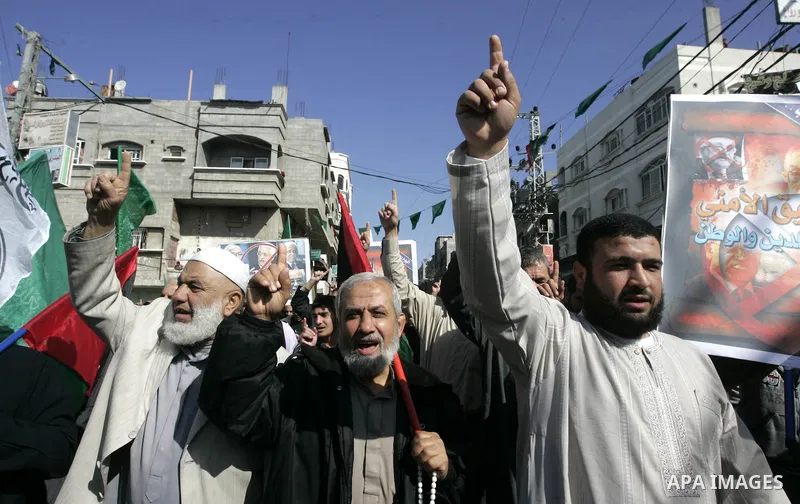 Palestinian Hamas activists protest against Palestinian President Mahmoud Abbas and his government following a recent broadcast by Al-Jazeera reportedly linking him to making broad concessions to Israel in peace talks, i...