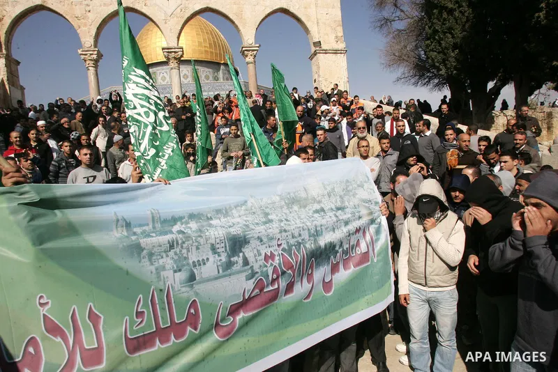 Backdropped by the Dome of the Rock Mosque, in the Al Aqsa Mosque compound, also known to Jews as Temple Mount, a Palestinian Hamas supporters take part in a demonstration against Palestinian President Mahmoud Abbas and...