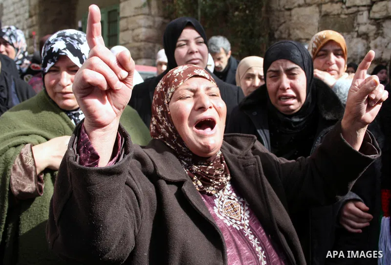Palestinian women mourn during the funeral of Youssef Ekhaleil in the West Bank village of Beit Omar, near Hebron, Saturday, Jan. 29, 2011. Ekhaleil died from wounds sustained during a clash with settlers on Friday Photo...