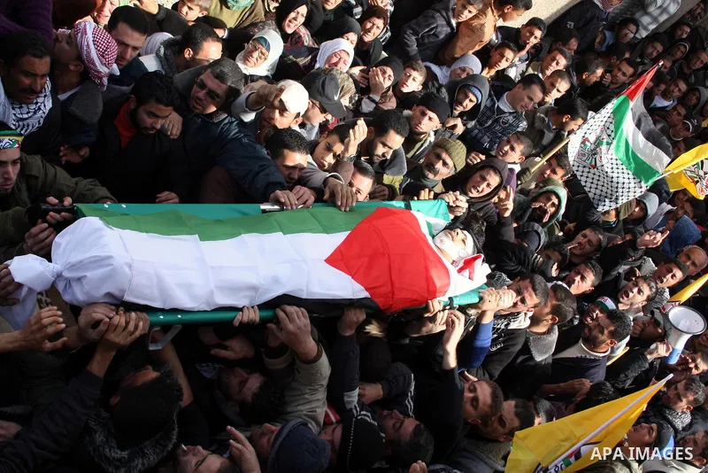 Palestinians carry the body of Youssef Ekhaleil during his funeral in the West Bank village of Beit Omar, near Hebron, Saturday, Jan. 29, 2011. Ekhaleil died from wounds sustained during a clash with settlers on Friday P...