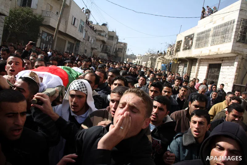 Palestinians carry the body of Youssef Ekhaleil during his funeral in the West Bank village of Beit Omar, near Hebron, Saturday, Jan. 29, 2011. Ekhaleil died from wounds sustained during a clash with settlers on Friday P...