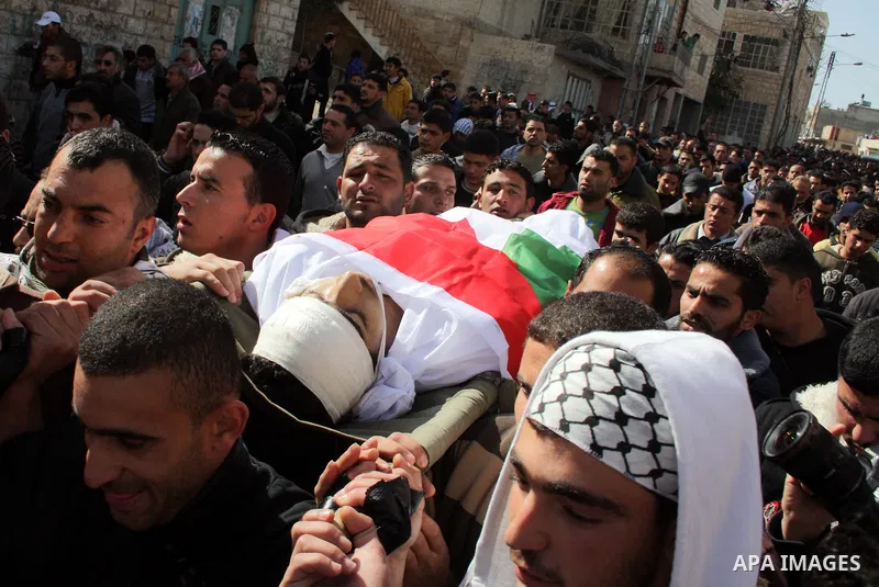 Palestinians carry the body of Youssef Ekhaleil during his funeral in the West Bank village of Beit Omar, near Hebron, Saturday, Jan. 29, 2011. Ekhaleil died from wounds sustained during a clash with settlers on Friday P...