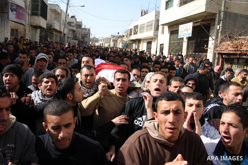 Palestinians carry the body of Youssef Ekhaleil during his funeral in the West Bank village of Beit Omar, near Hebron, Saturday, Jan. 29, 2011. Ekhaleil died from wounds sustained during a clash with settlers on Friday P...
