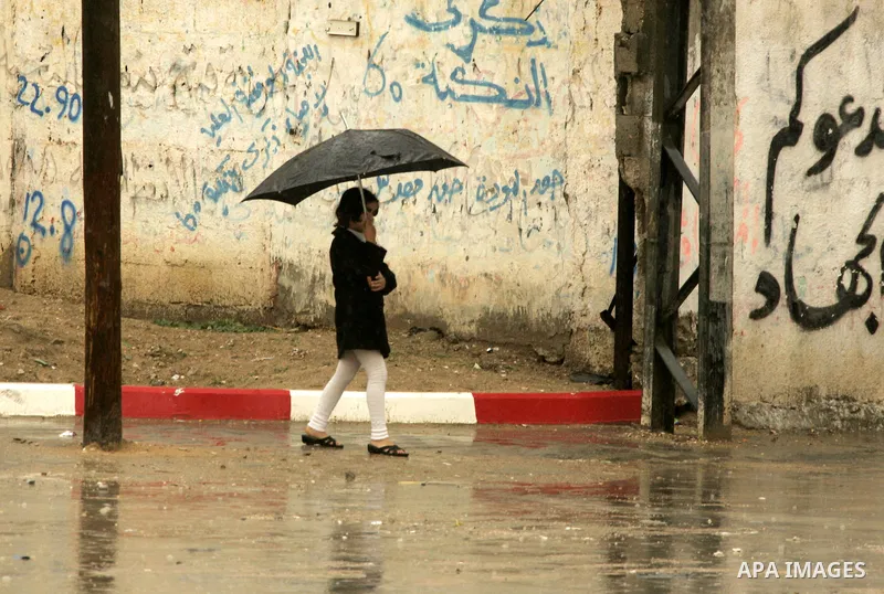 A Palestinian girl walks in a street during heavy rain in the southern Gaza Strip town of Rafah, Tuesday, Feb. 1 , 2011. Photo by Abed Rahim Khatib