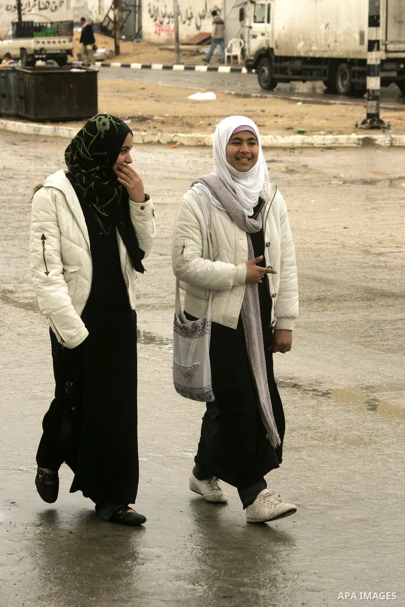 Palestinian girls walk in a street during heavy rain in the southern Gaza Strip town of Rafah, Tuesday, Feb. 1 , 2011. Photo by Abed Rahim Khatib