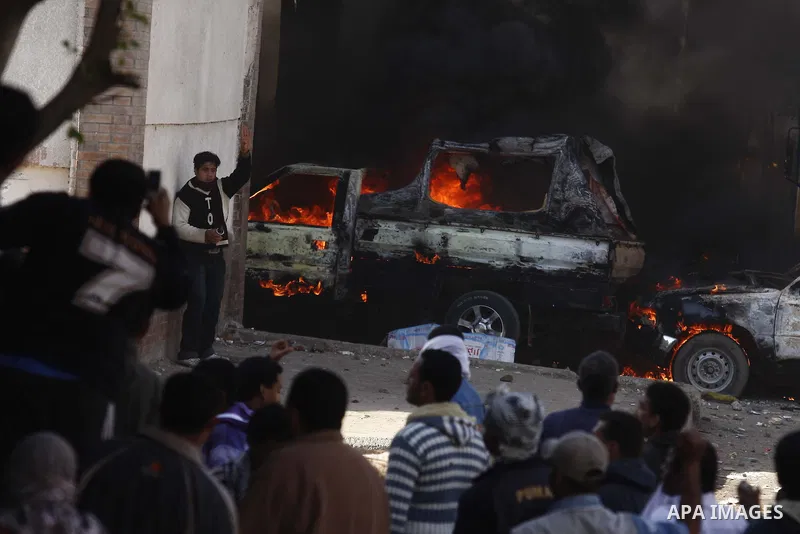 Police vehicles are set on fire by anti-government demonstrators in Cairo, capital of Egypt, on Friday, Jan. 28, 2011. Photo by Karam Nasser
