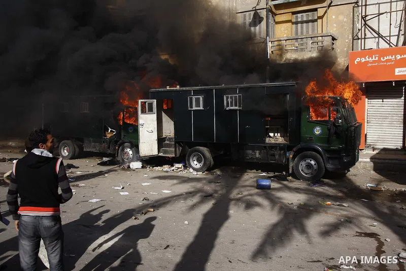 Police vehicles are set on fire by anti-government demonstrators in Cairo, capital of Egypt, on Friday, Jan. 28, 2011. Photo by Karam Nasser