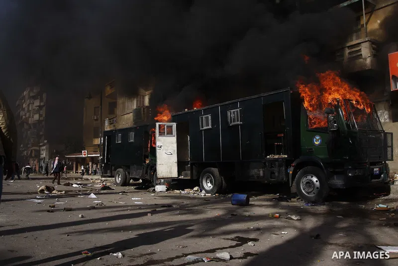 Police vehicles are set on fire by anti-government demonstrators in Cairo, capital of Egypt, on Friday, Jan. 28, 2011. Photo by Karam Nasser
